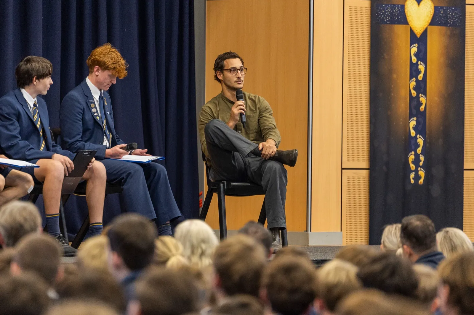 A NetNada team member speaking to a school assembly about sustainability