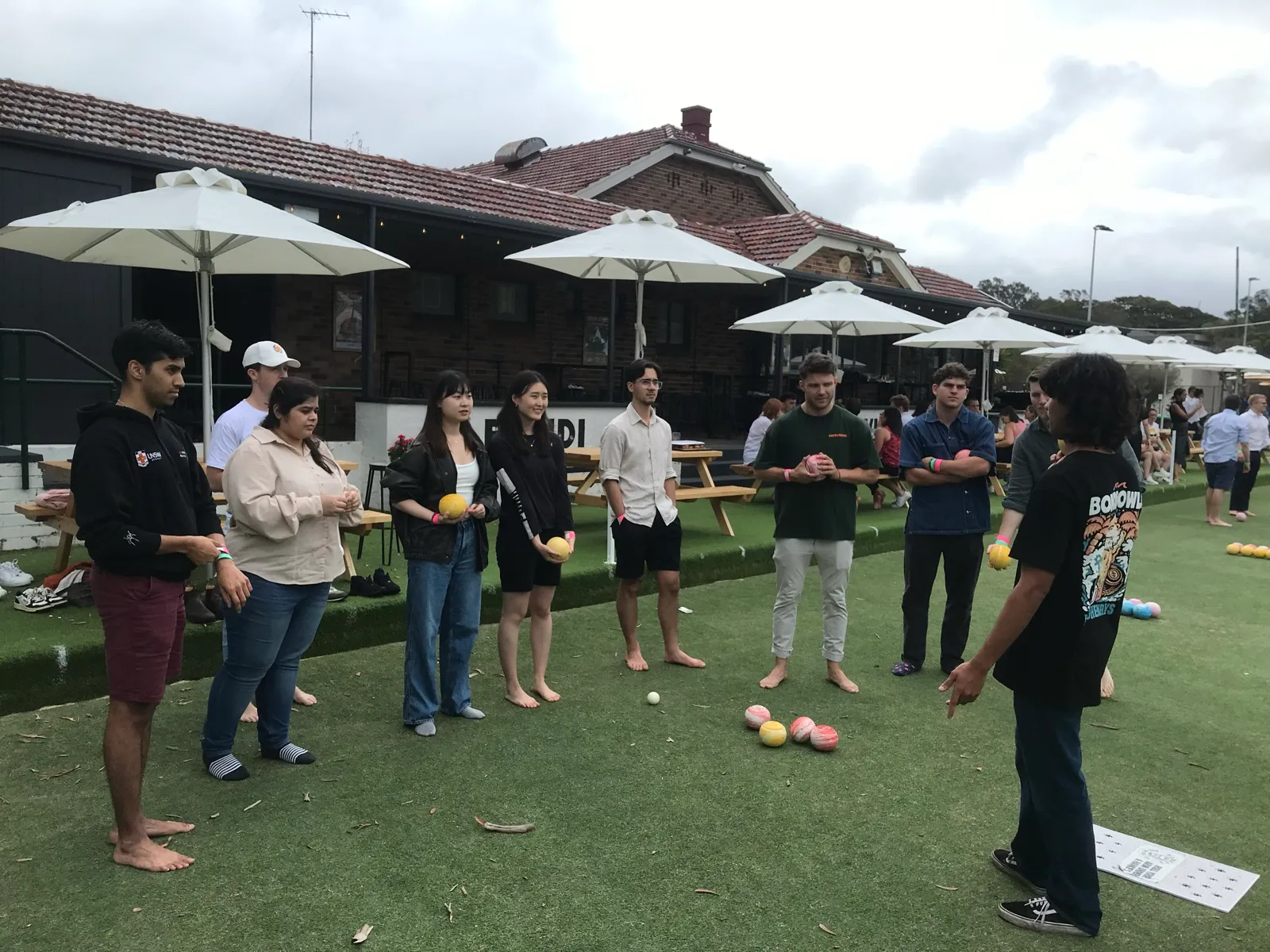 Barefoot lawn bowls at a team day
