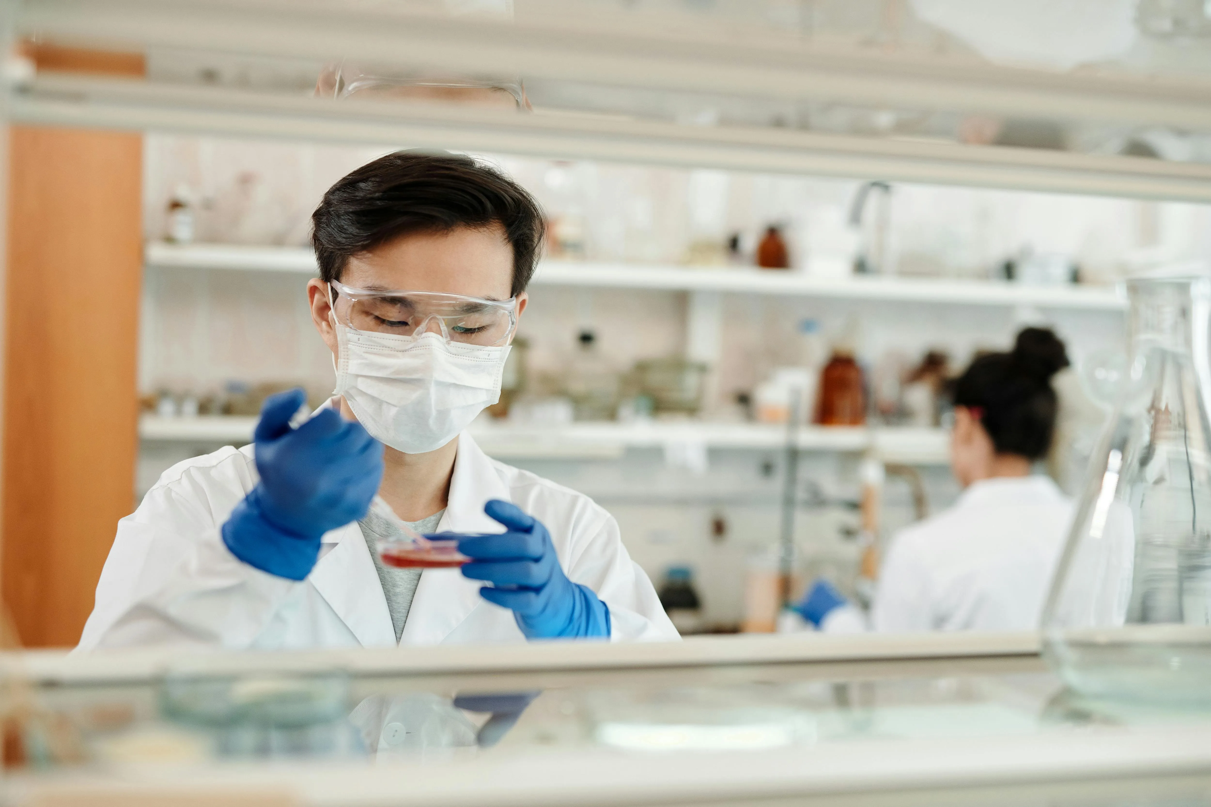 image of a lab technician testing chemicals for healthcare