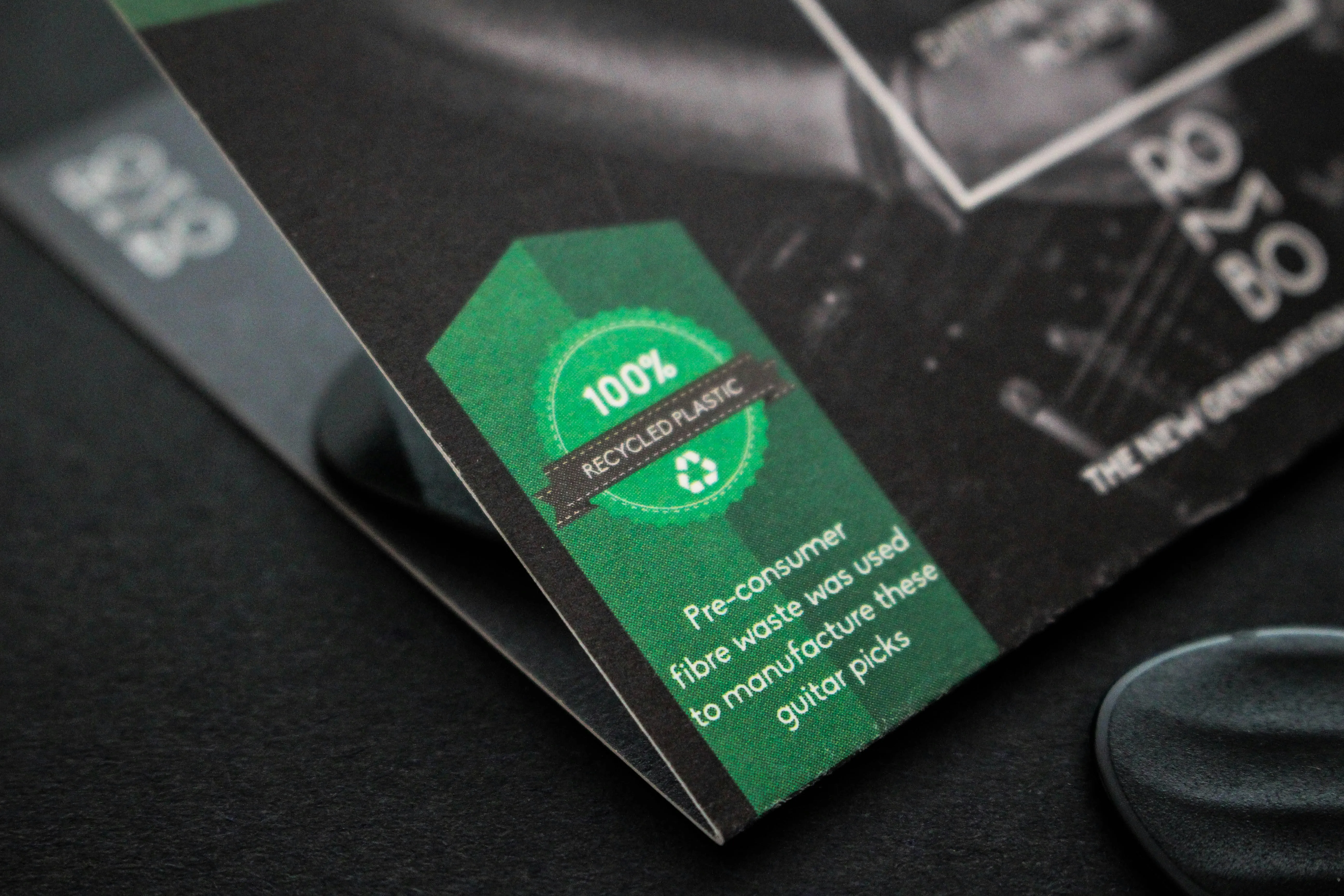 image of a brochure of a guitar pick stating it is 100% recycled